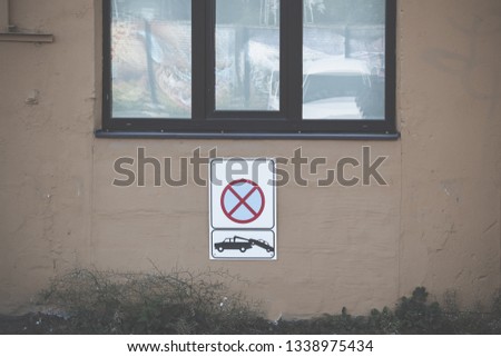 No parking sign hanging on the wall.
Car evacuation sign