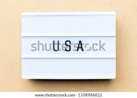 White lightbox with word USA (United states of America) on wood background