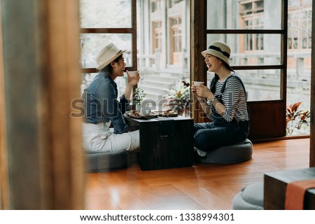 group of best friends sitting wooden old house floor holding matcha tea bowl doing chanoyu. asian woman travel in tokyo lifestyle. laughing young girls talking drinking enjoy in japanese garden Royalty-Free Stock Photo #1338994301