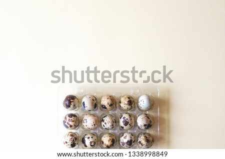 Plastic packaging with quail eggs on a yellow background. 