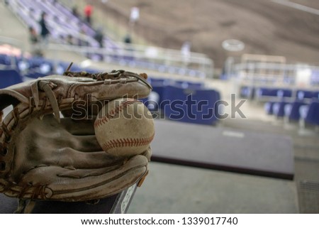 Glove and baseball on stands
