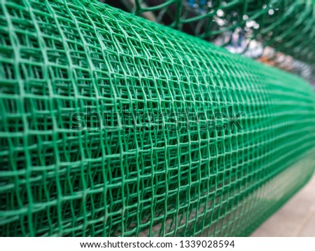 Grid for the house and a garden of green color. Roll of a garden plastic lattice