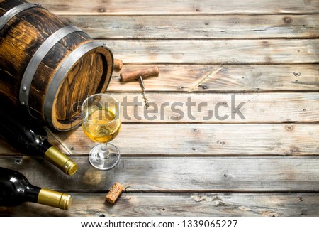 Wine background. Barrel of white wine. On a wooden background.
