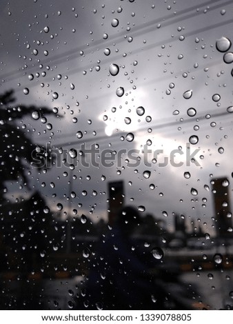 beautiful of Rain drops on window with the sun shines