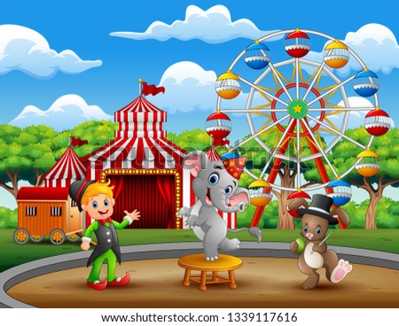 Circus trainer performance with elephant and rabbit