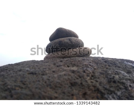 Pebble pile on the beach with a sea background