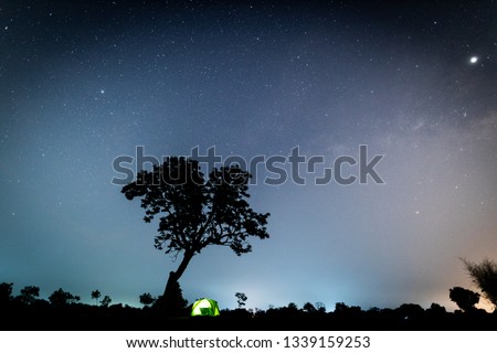 Night landscape with colorful with noise and gray .Milky Way and yellow light at mountains. Starry sky with hills at summer. Beautiful Universe. Space background - Image