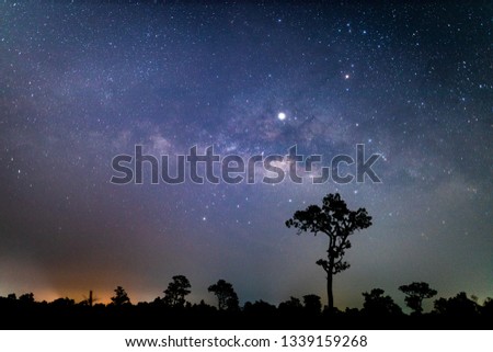 Night landscape with colorful with noise and gray .Milky Way and yellow light at mountains. Starry sky with hills at summer. Beautiful Universe. Space background - Image
