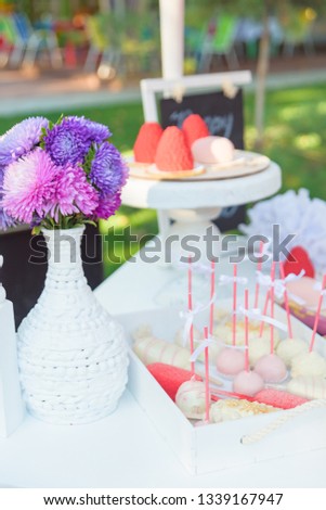 Eclairs with pink glaze. Heart-shaped cakes. Candy bar. Girl's birthday. Sweet pastries. Confectionery dessert red. Bouquet of flowers in a vase. Cake POPs.