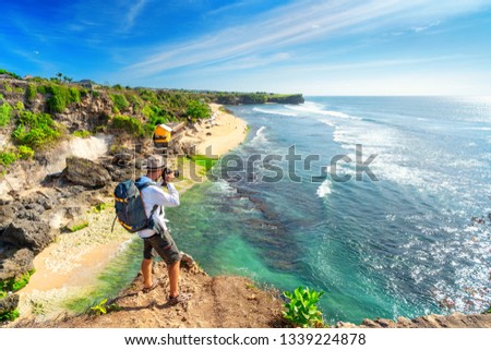 Man photographer with big backpack and camera taking photo of sunset mountains Travel Lifestyle hobby concept adventure active vacations outdoor