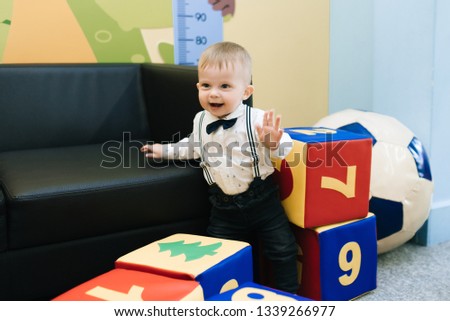 Cute kid playing in the children's center. Funny childhood