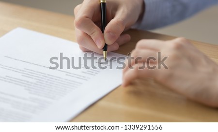 Close up businesswoman signing contract, putting signature on business document, candidate filling employment agreement, client taking loan, mortgage, making deal, female hands writing on paper Royalty-Free Stock Photo #1339291556