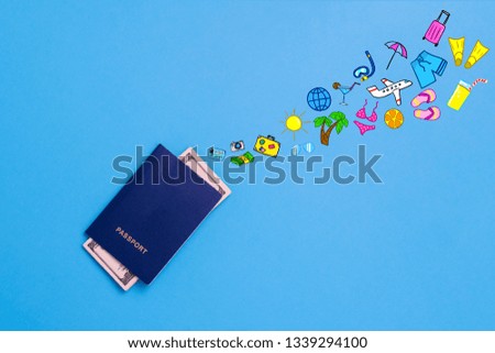 Passports and Banknotes of dollars and added icons of the Travel and Rest on the Blue background. Minimalistic style. Concept of Travel and Holidays. Flat lay, top view