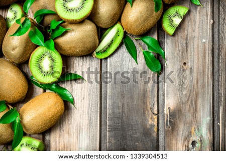 Kiwi slices with leaves. On wooden background