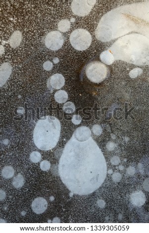 Frozen ice with a lot of ice bubbles and cracks