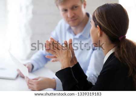 Two business people new employee and employer having dialogue. Man from human resource management interviewing lady, negotiation, recruiting, consulting, sale broker negotiating with client. Side view Royalty-Free Stock Photo #1339319183
