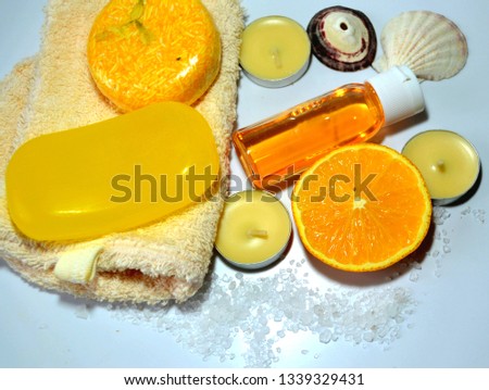 Spa composition of organic orange skin and hair care products of tonic, mood-enhancing  and vitaminizing action with handmade dry shampoo, soap, citrus shampoo, towels, seashells, candles, orange slic