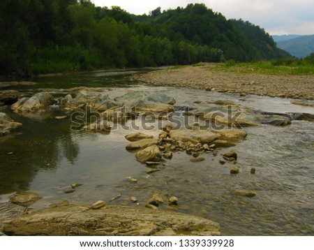 Beautiful mountain river with cascades on a summer day