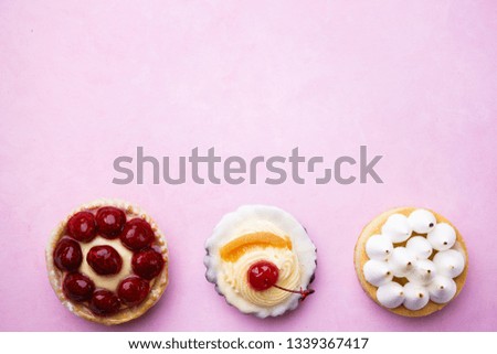 cakes background. delicious assorted desserts. cream cheese cupcake, berry tart, lemon meringue tart. home crafted sweet treats, confectionery