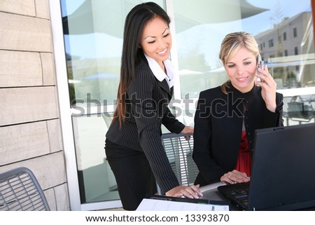 Attractive, young, diverse business woman team working on laptop computer