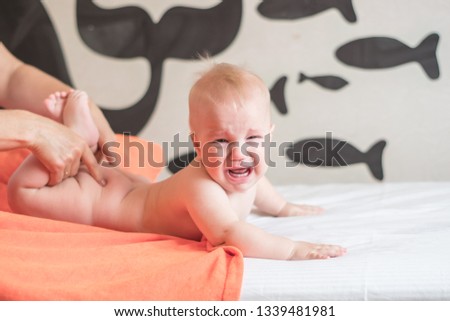 Doctor pediatric terapist a back and lumbar phisical massage to the newborn child for proper body shaping and body development. Baby back massage Royalty-Free Stock Photo #1339481981