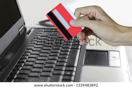 Hand holding credit card and using laptop, Online shopping concept