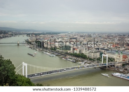 Budapest - capital of Hungary big medieval city urban landmark view aerial photography from above with bridge across Danube river in cloudy foggy autumn season weather time