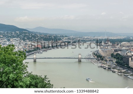 Budapest - capital of Hungary big medieval city urban landmark view aerial photography from above with bridge across Danube river in cloudy foggy autumn season weather time
