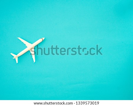 Airplane model, on blue trendy paper. space for text. stylish creative image. travel. summer vacation concept