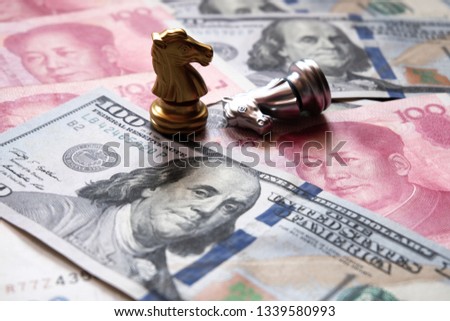 Chess game on US dollar and Chinese yuan bank note. Trade war and conflict between two big countries. USA and China relationship concept. Copy space. Royalty-Free Stock Photo #1339580993