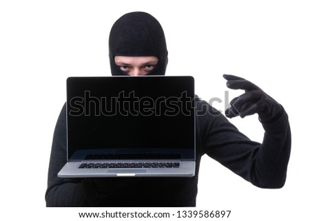 Robber in black mask with laptop with blank screen in hands.