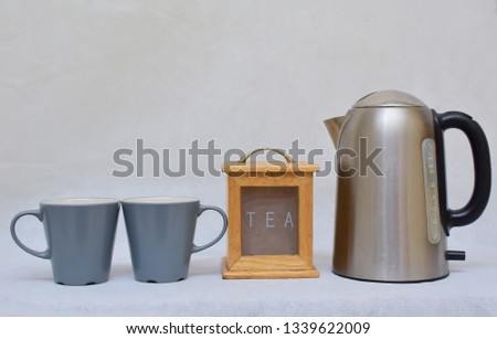 Mockup / design set of colorful Tea or coffee ceramic mug beside wooden tea kitchen box and stainless steel kettle .  template for branding identity and company logo design/ drink-ware, Dining 