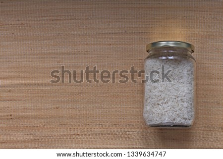 Flat lay of white rice in glass jar. Bulk shopping without plastic packaging