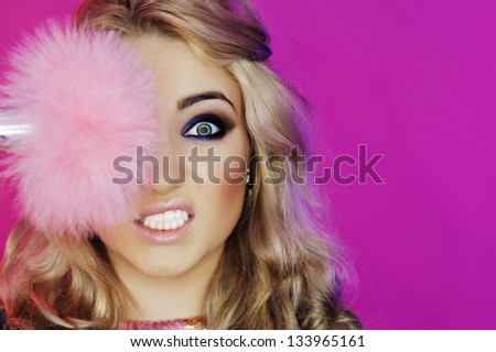 Eyes of the girl in the professional making up / Carnival makeup with pink feathers