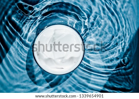 Sensitive skincare moisturizer cream on water background - clean beauty, cosmetic products and luxury body care concept. Natural science for your skin Royalty-Free Stock Photo #1339654901