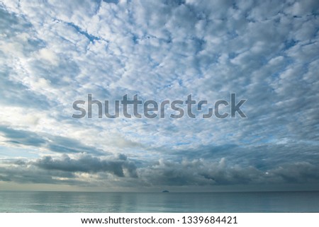 Cloudy on blue sky during morning sunrise at dawn in summer spring over the sea at Rayong, Thailand.