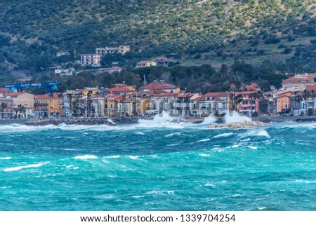 Stormy and Windy Mediterranean Sea with a Village in the Distance