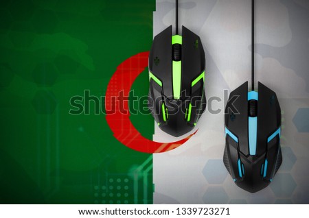 Algeria flag  and two mice with backlight. Online cooperative games. Cyber sport team