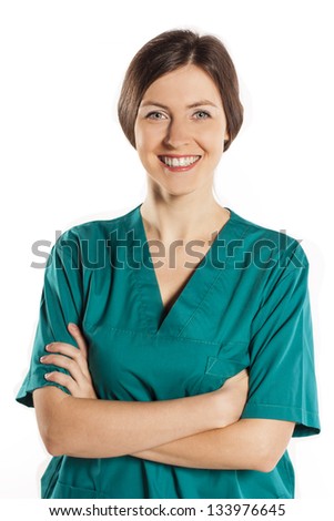 Portrait of happy young doctor woman standing with arms crossed.