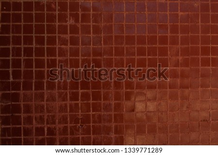 Small brown square ceramic tiles on the wall