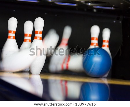 Bowling ball hitting motion blurred pins