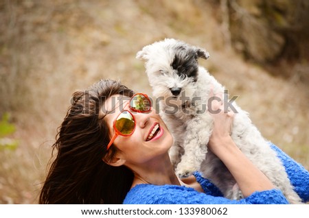 beautiful girl hugging her  little cute dog