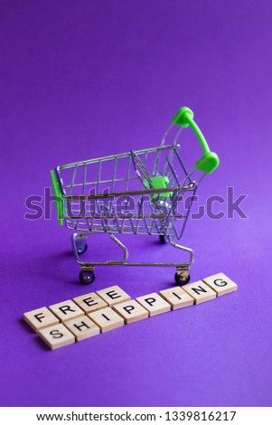 Empty shopping basket with words free shipping on blue background, free shipping 