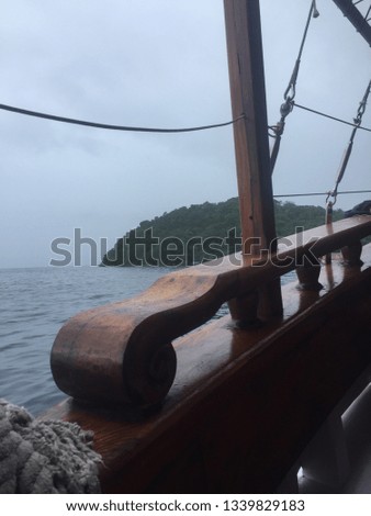 A picture from inside a boat looking at a island