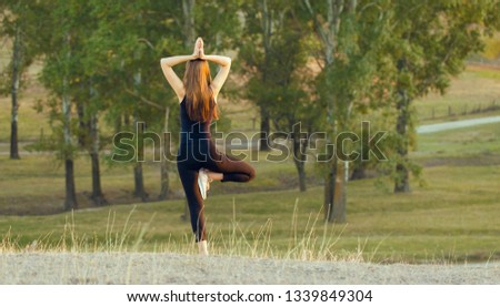 Young beautiful girl doing yoga in nature.