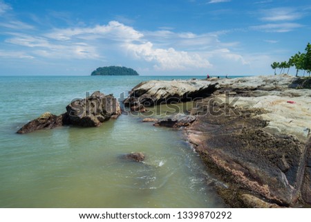 Blue sky on a beach with Rocks, blue sea,  around Portuguese Fortress. On the other side is Mandalika Island, Jepara, Indonesia.