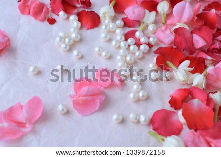 flower petals and pearl on paper.