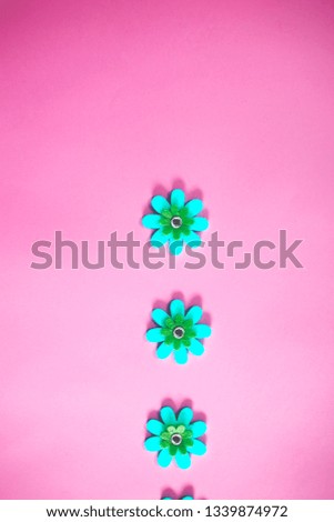 beautiful minimal bright colorful close up top view flat lay photo of small fake flowers on bright background with copy space