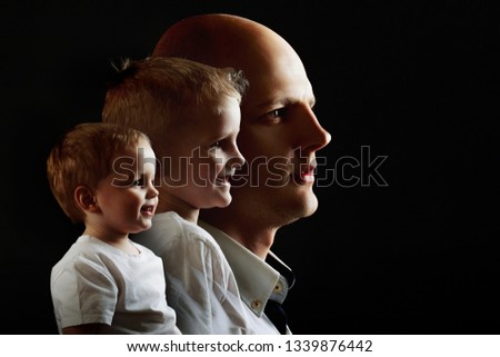 Man's growing up, kid, boy, guy. concept of human adulthood. portrait in profile on black background Royalty-Free Stock Photo #1339876442