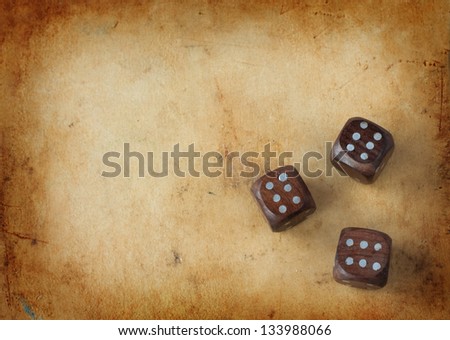 Three wooden dices on a vintage background - gambling lucky streak concept with free text space